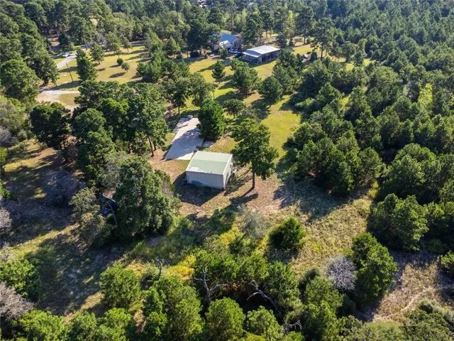 an aerial view of residential house with outdoor space and swimming pool
