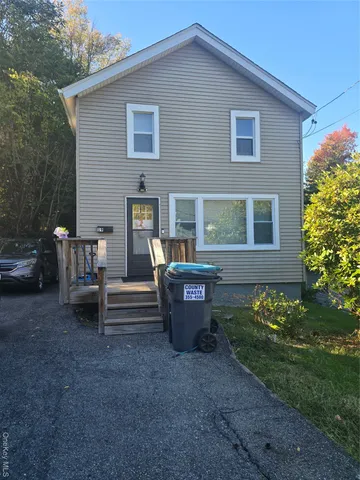 a wooden bench sitting in front of a house