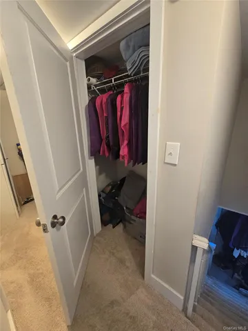 a bedroom with furniture and a gym machine