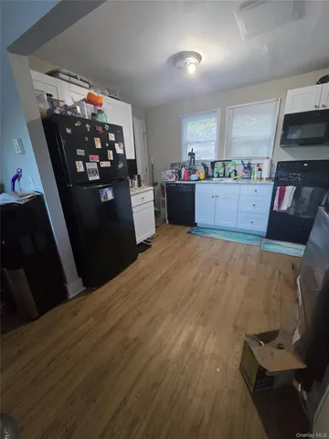 a kitchen with stainless steel appliances kitchen island granite countertop a refrigerator stove and sink