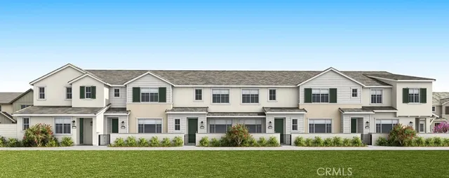 a front view of a house with a yard and trees