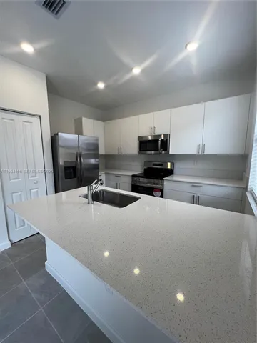 an empty room with windows and entrance