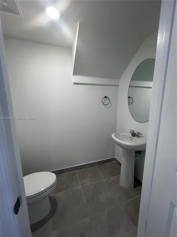 a bathroom with a toilet and a bath tub