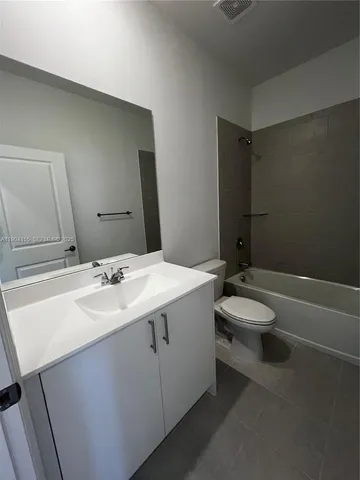 a living room with kitchen furniture and a large window