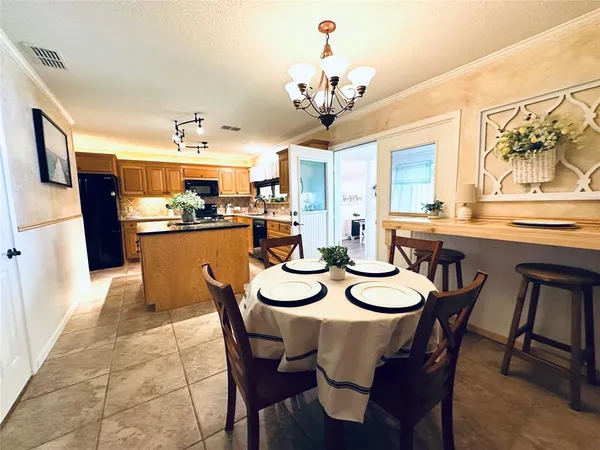 a view of a dining room with furniture and chandelier