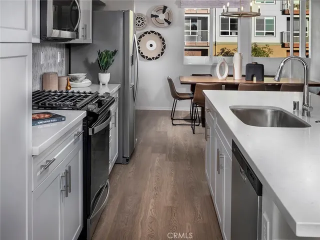 a kitchen with stainless steel appliances granite countertop a stove and a sink