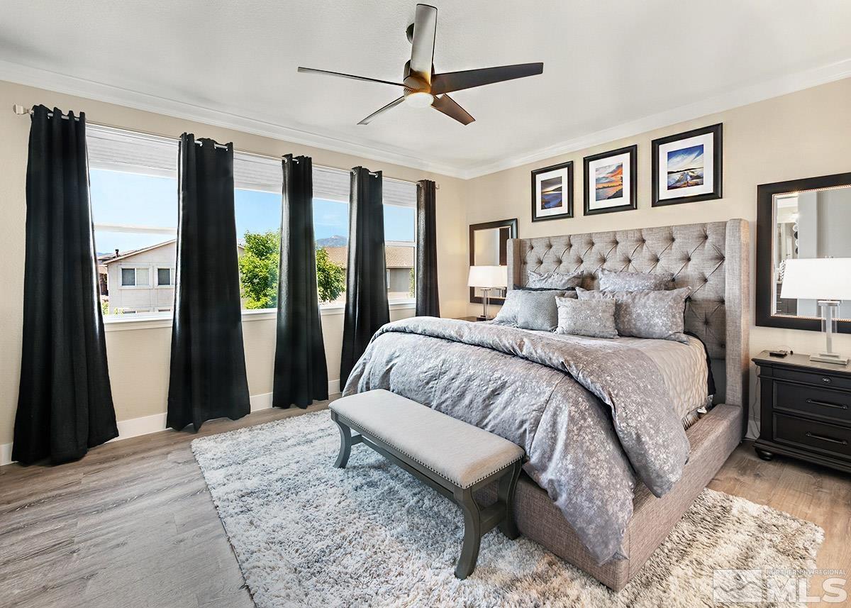 2552 Country Falls Lane Reno, NV 89521 - Photo 11 of 40 a spacious bedroom with a large bed and a chandelier