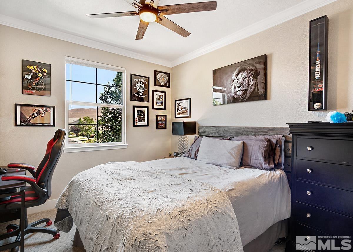 2552 Country Falls Lane Reno, NV 89521 - Photo 19 of 40 a bedroom with a bed and a chandelier