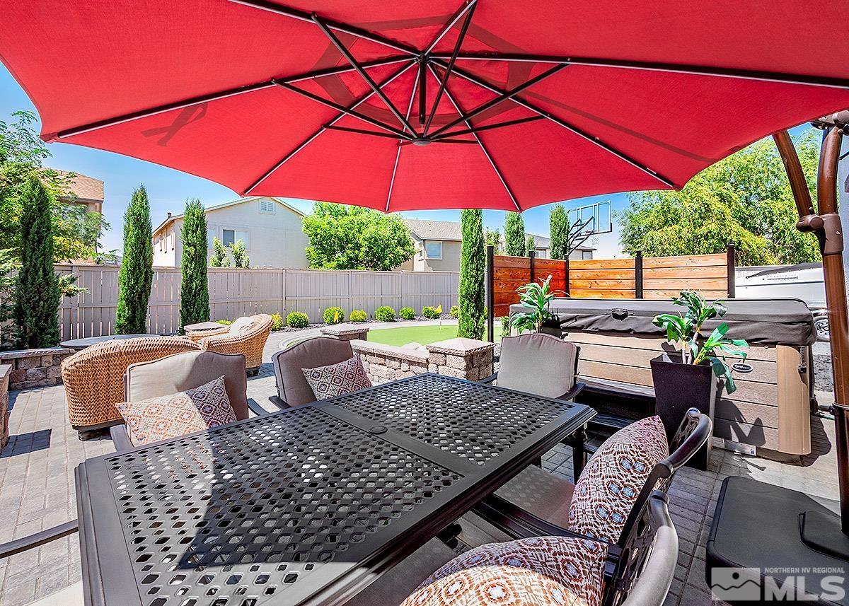 2552 Country Falls Lane Reno, NV 89521 - Photo 28 of 40 a view of an outdoor sitting area with furniture and umbrella