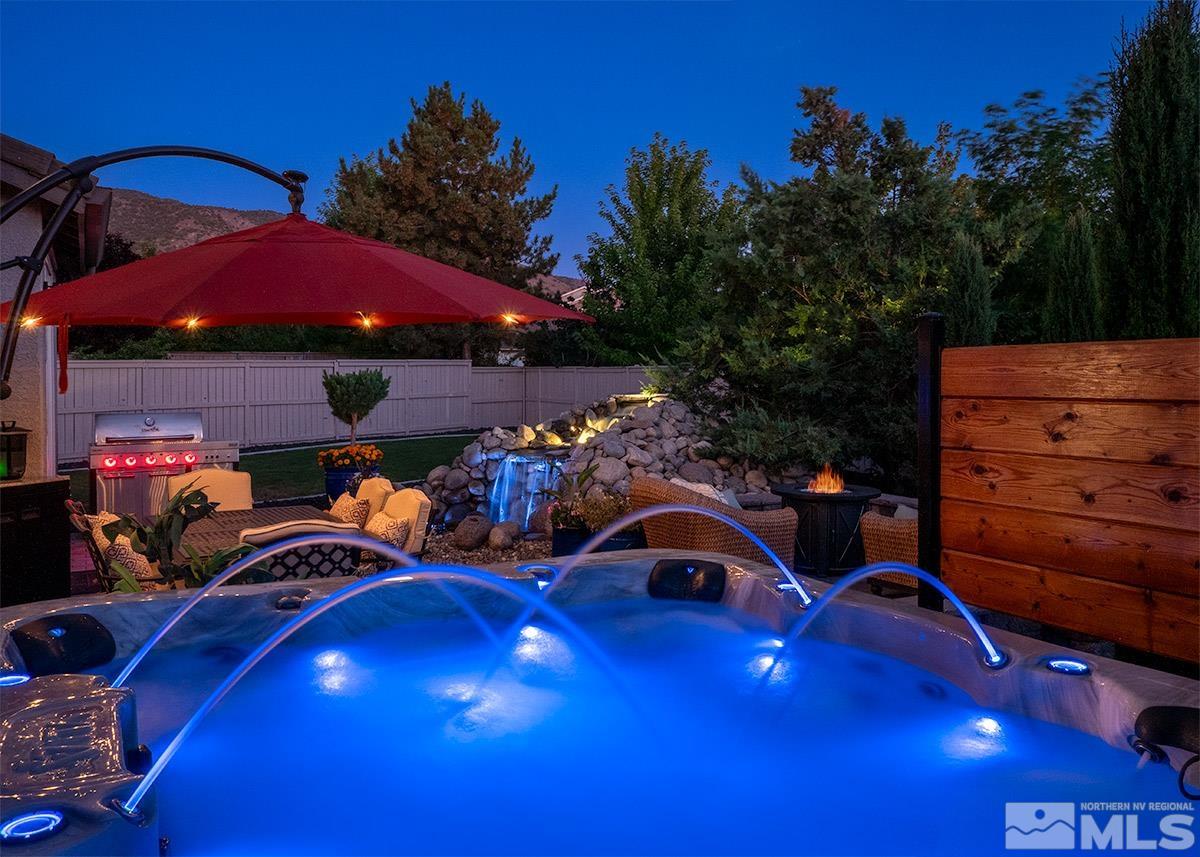 2552 Country Falls Lane Reno, NV 89521 - Photo 35 of 40 a view of a patio with table and chairs under an umbrella