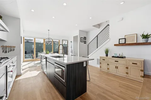 a kitchen with stainless steel appliances granite countertop a stove and a sink