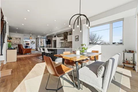 a dining room with furniture and wooden floor
