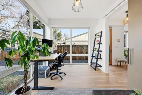 a workspace with furniture and a potted plant