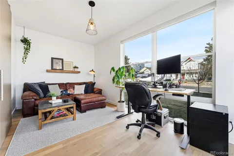 a work room with furniture and a flat screen tv