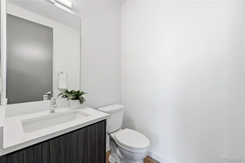a bathroom with a sink a toilet and mirror