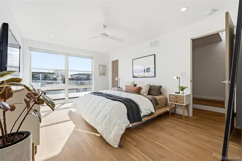 a spacious bedroom with a bed and a large window