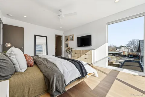 a bedroom with a bed and a flat screen tv