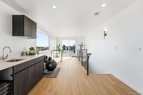 a open kitchen with sink cabinets and wooden floor