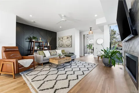 a living room with furniture a large window and a flat screen tv