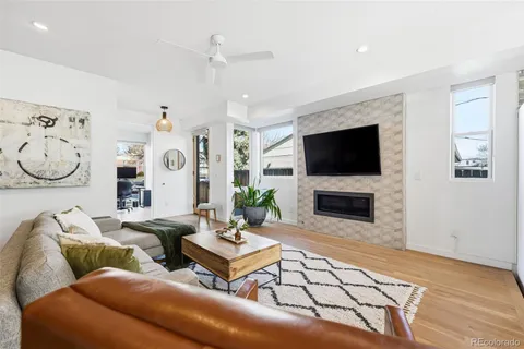 a living room with furniture a rug and a fireplace