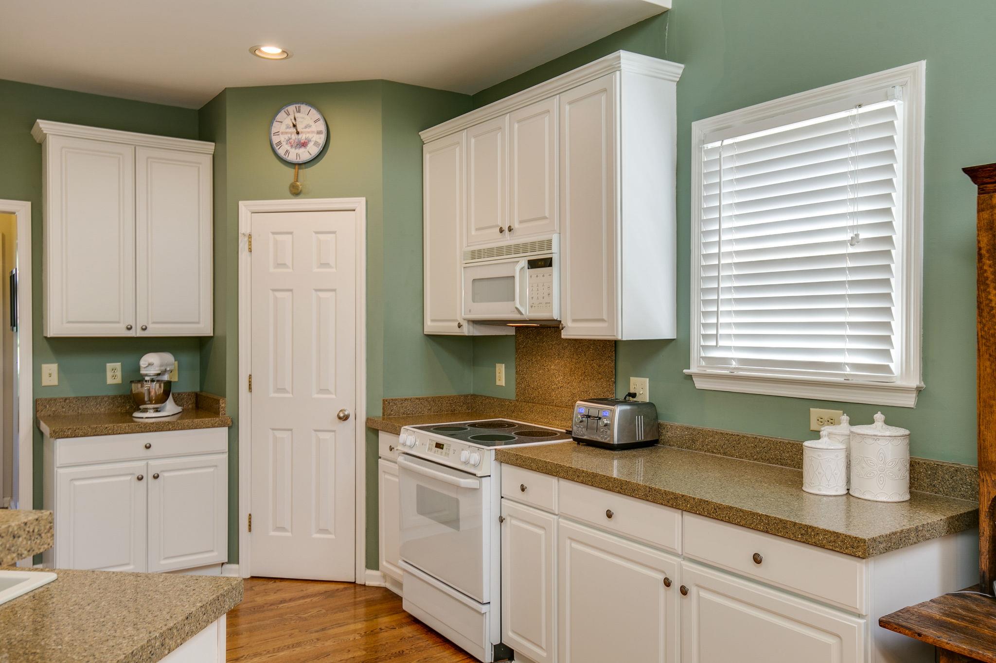 114 Chester Stevens Road Franklin, TN 37067 - Photo 11 of 30 a kitchen with granite countertop a sink cabinets and stainless steel appliances