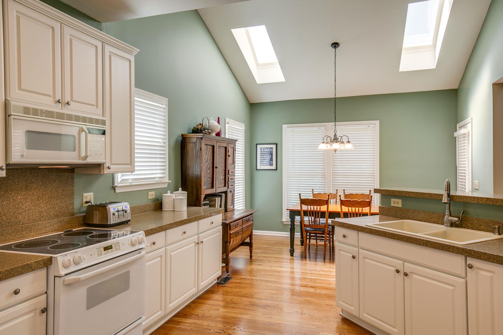 114 Chester Stevens Road Franklin, TN 37067 - Photo 13 of 30 a kitchen with stainless steel appliances granite countertop a sink a stove and a wooden floors