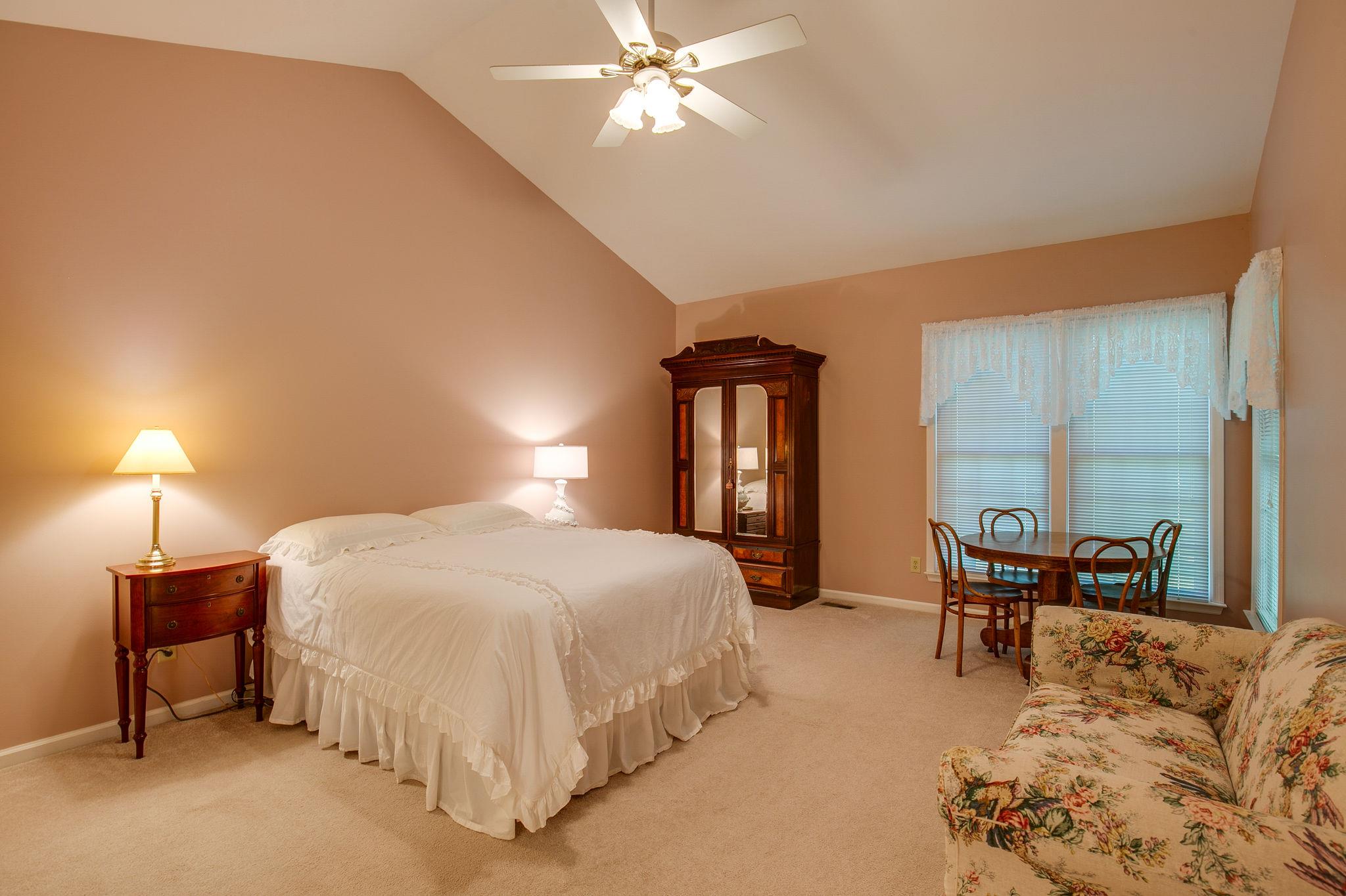 114 Chester Stevens Road Franklin, TN 37067 - Photo 16 of 30 a bedroom with a bed and a chandelier