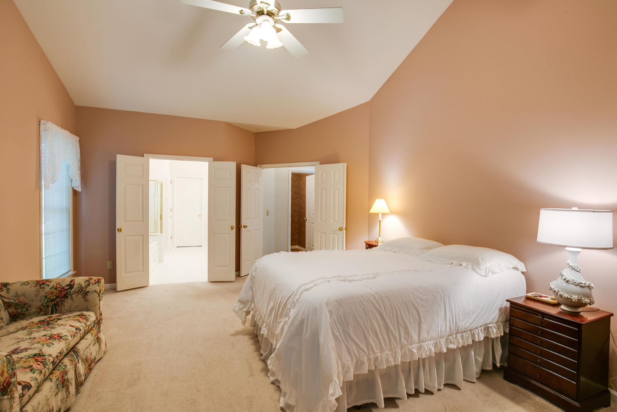 114 Chester Stevens Road Franklin, TN 37067 - Photo 17 of 30 a bedroom with a bed and a chandelier