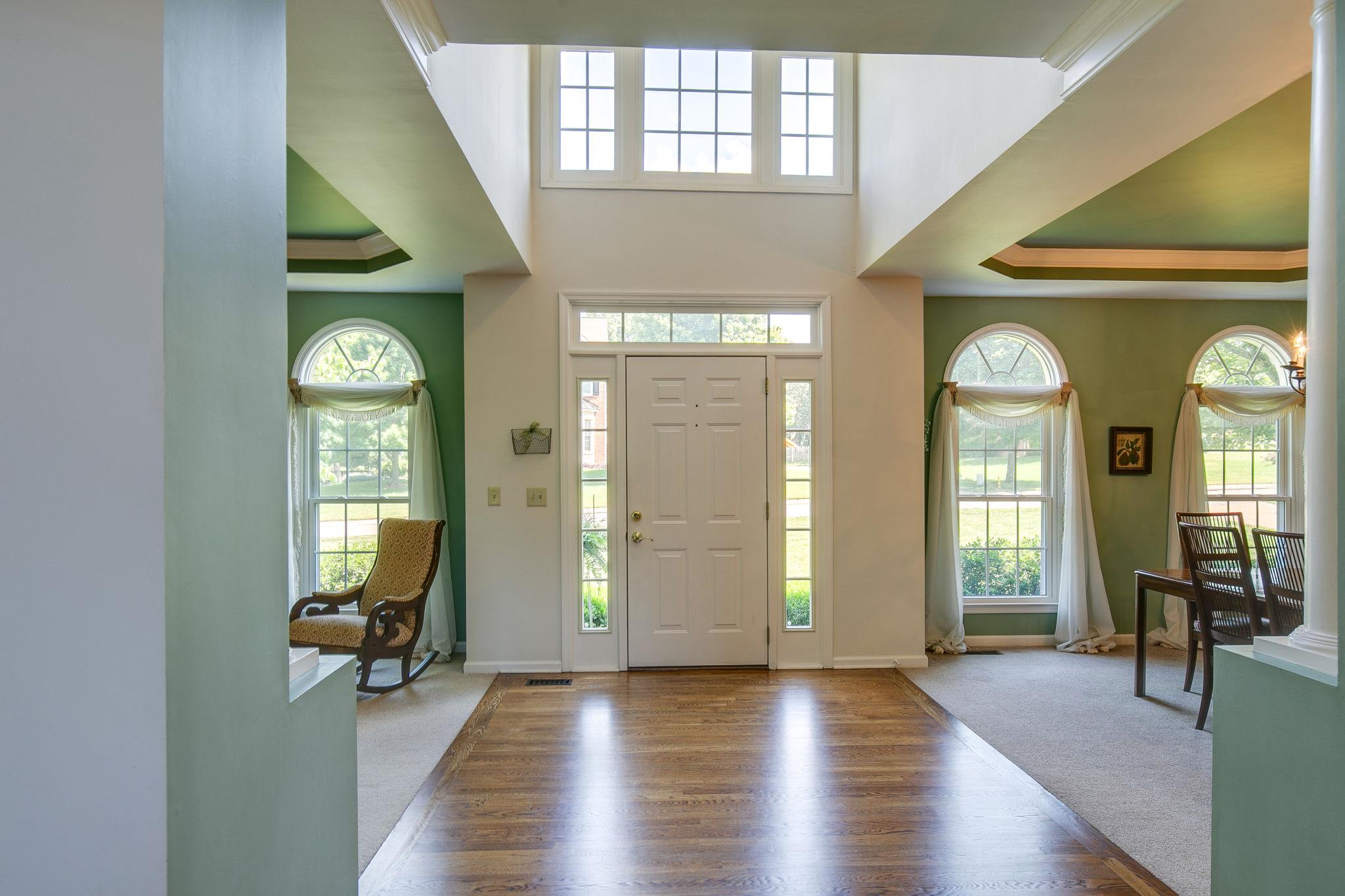 114 Chester Stevens Road Franklin, TN 37067 - Photo 4 of 30 a view of a hallway with wooden floor windows and a livingroom