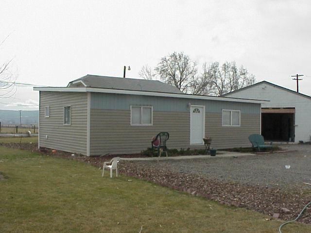 1121 North Outlook Road Outlook, WA 98938 - Photo 2 of 4 a backyard of a house with barbeque oven table and chairs