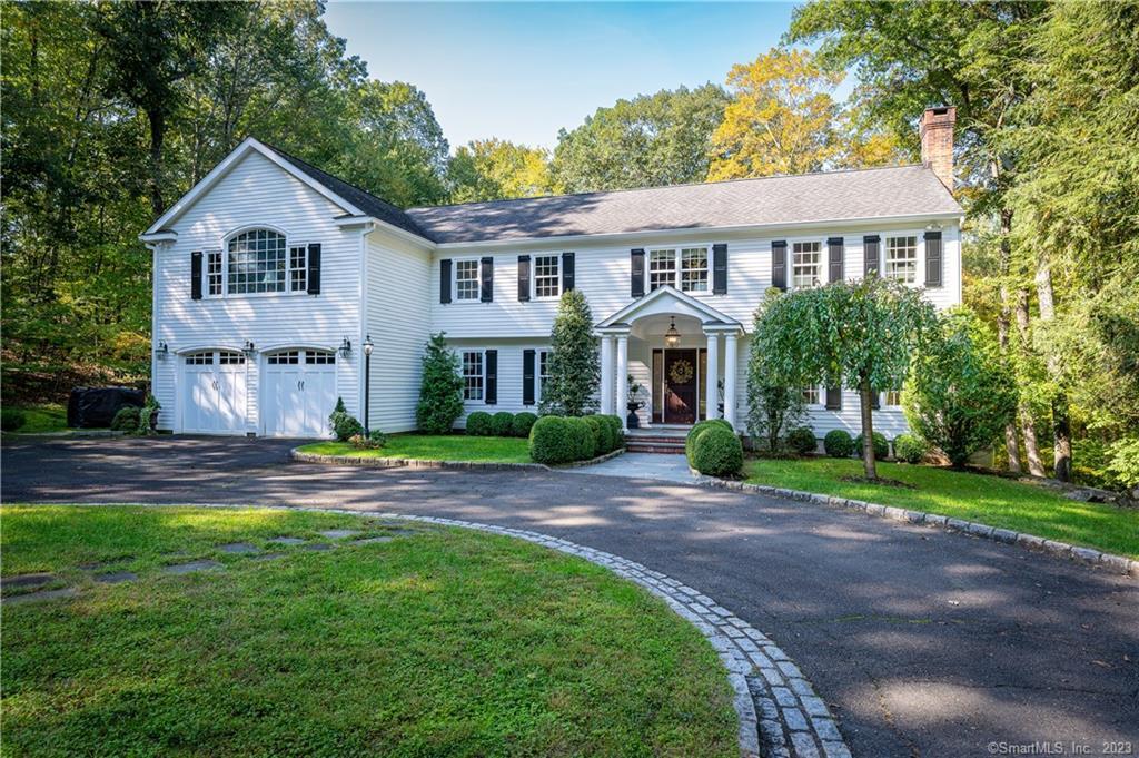 40 Bryants Brook Road Wilton, CT 06897 - Photo 1 of 1 a front view of a house with a yard and garage