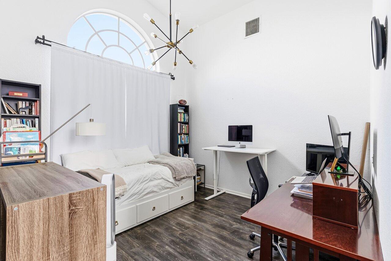 9507 Lake Serena Drive Boca Raton, FL 33496 - Photo 11 of 26 a bedroom with furniture and a wooden floor