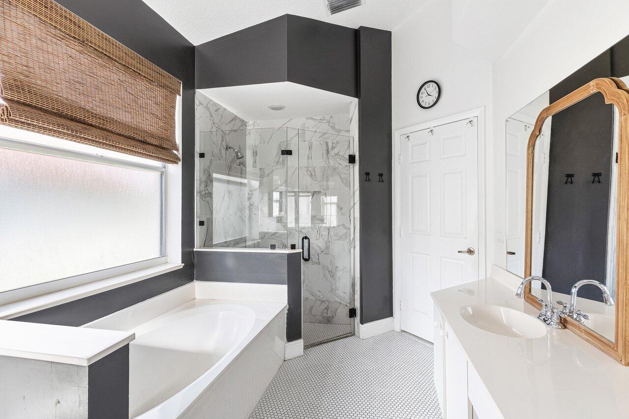 9507 Lake Serena Drive Boca Raton, FL 33496 - Photo 14 of 26 a bathroom with a tub sink and mirror