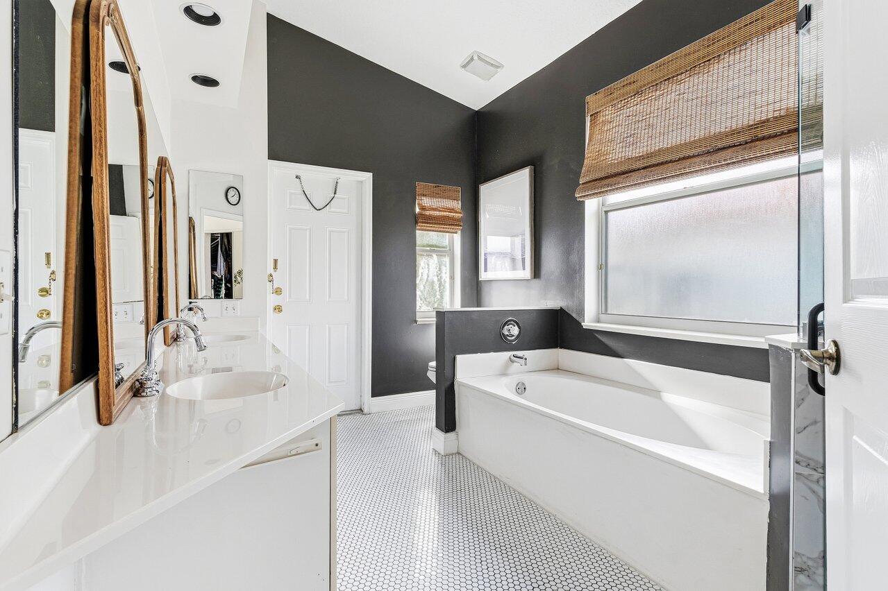 9507 Lake Serena Drive Boca Raton, FL 33496 - Photo 15 of 26 a bathroom with a tub sink and mirror