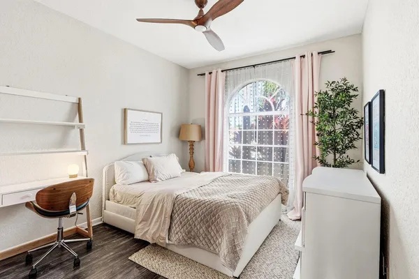 a bedroom with a bed and glass window