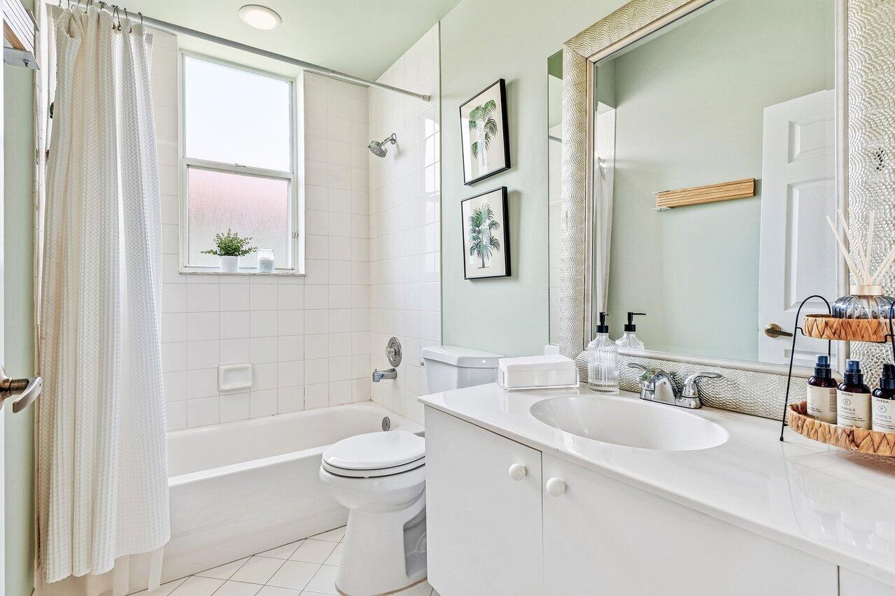 9507 Lake Serena Drive Boca Raton, FL 33496 - Photo 17 of 26 a bathroom with a granite countertop sink a toilet a shower and a mirror