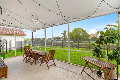 a view of a chair and tables in the patio