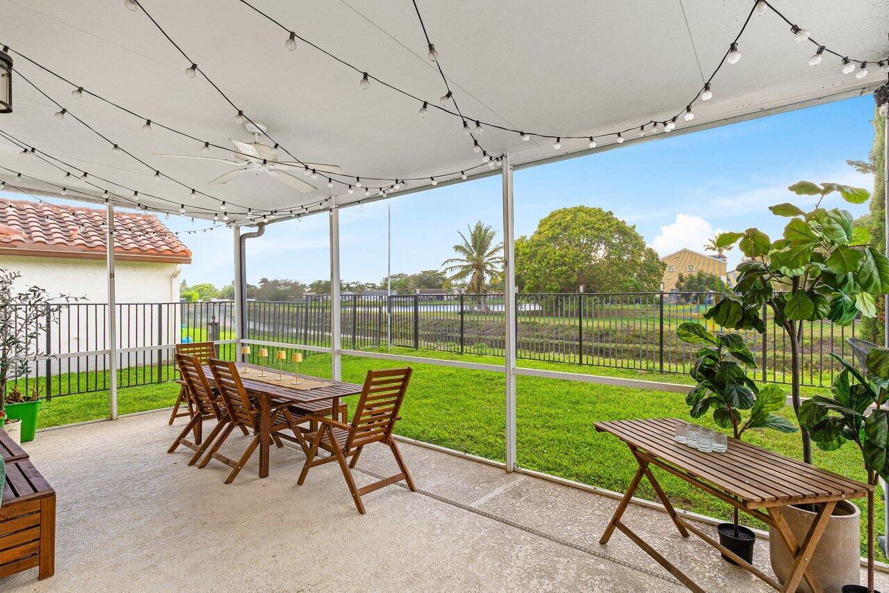 9507 Lake Serena Drive Boca Raton, FL 33496 - Photo 20 of 26 a view of a chair and tables in the patio