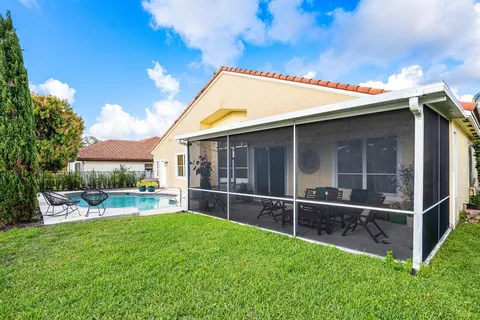 a view of an house with backyard space and sitting area