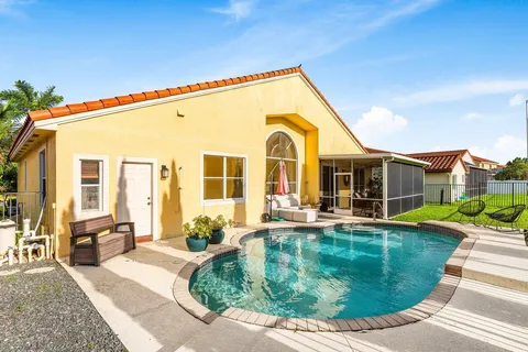 a view of a house with swimming pool and porch