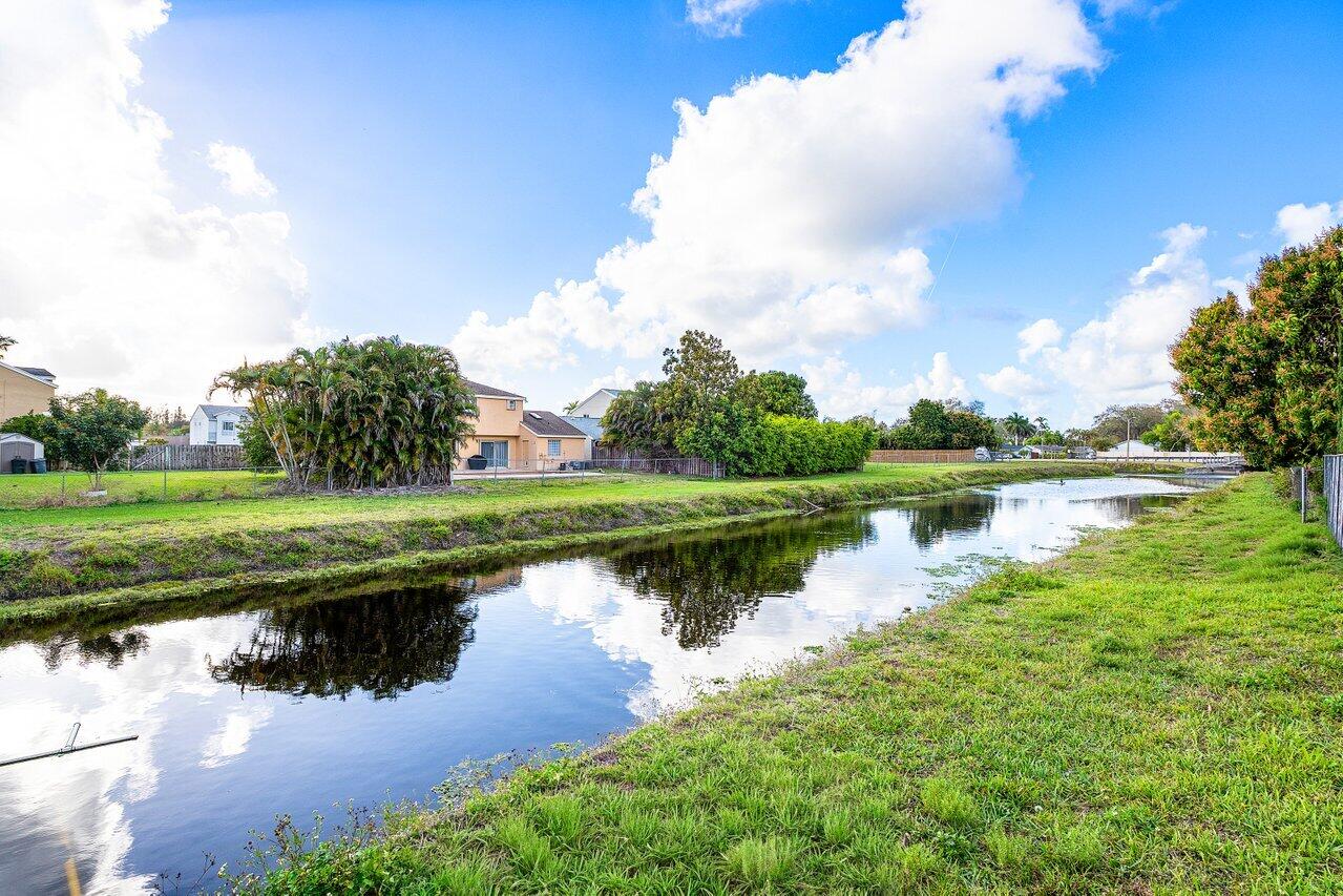 9507 Lake Serena Drive Boca Raton, FL 33496 - Photo 25 of 26 a view of a lake with a big yard