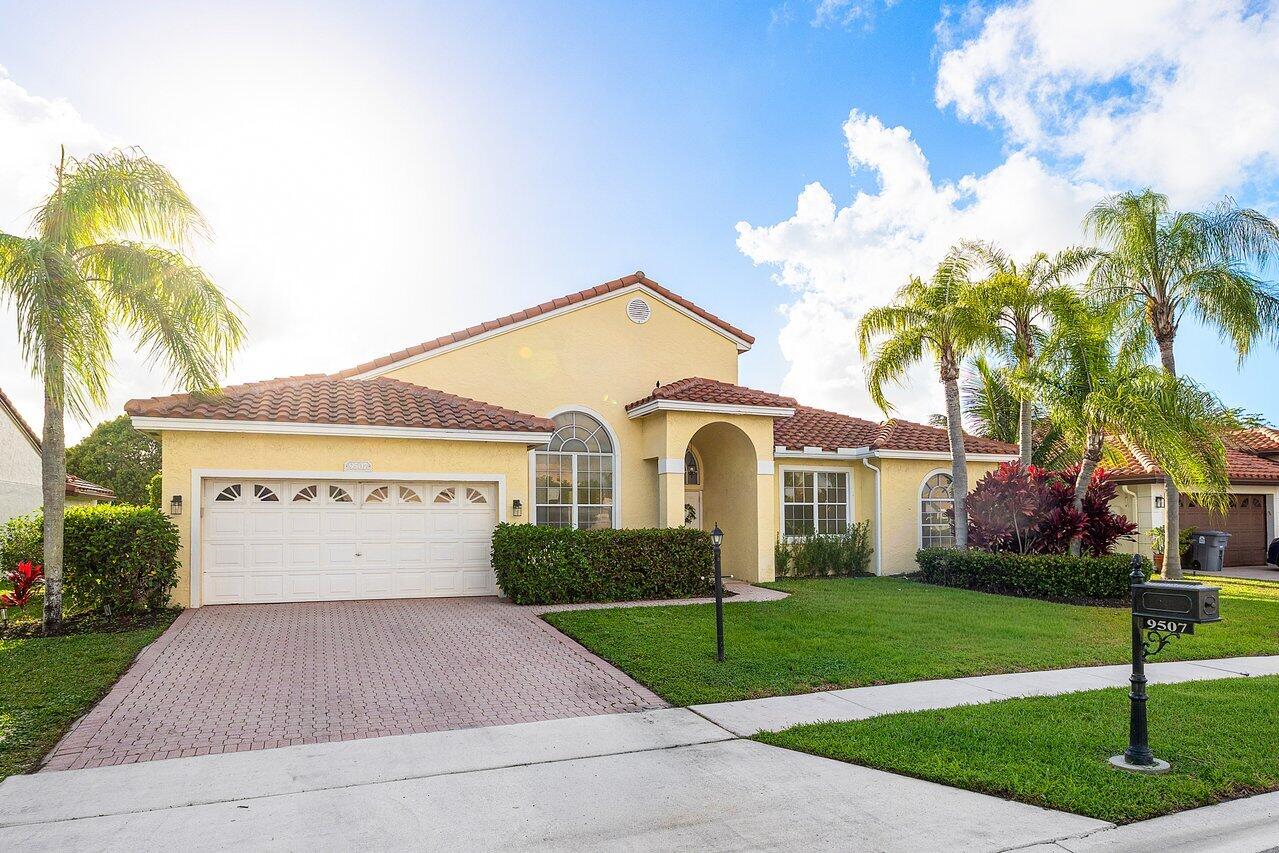 9507 Lake Serena Drive Boca Raton, FL 33496 - Photo 26 of 26 a front view of a house with garden