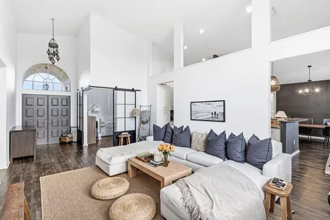 a living room with furniture a table and chairs