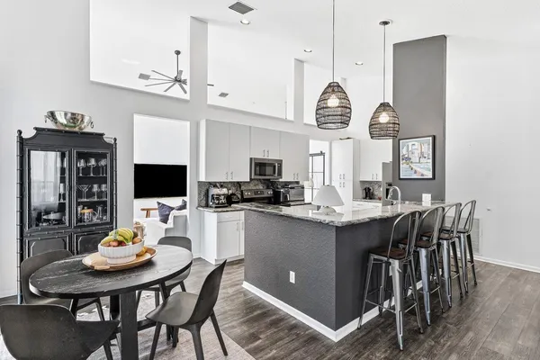 a kitchen with a table chairs and a stove