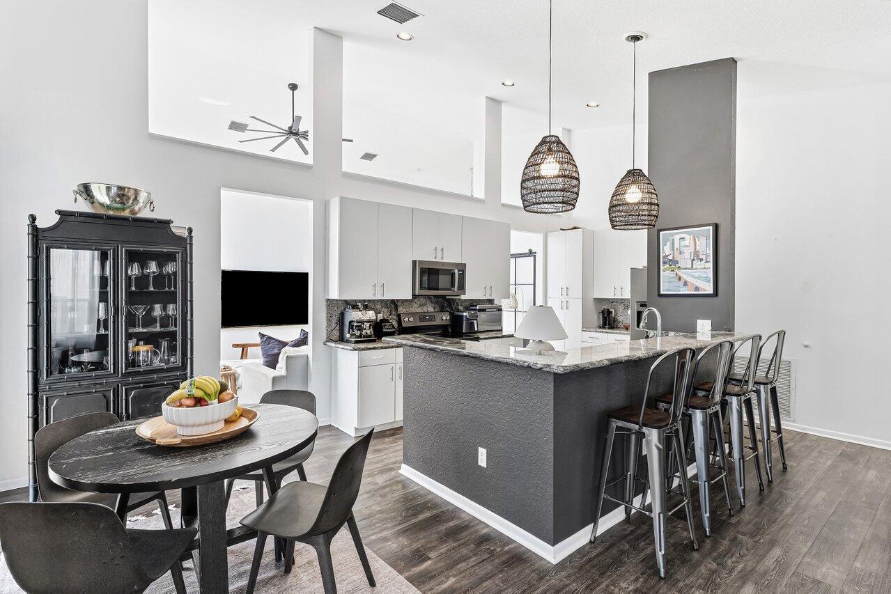 9507 Lake Serena Drive Boca Raton, FL 33496 - Photo 7 of 26 a kitchen with a table chairs and a stove