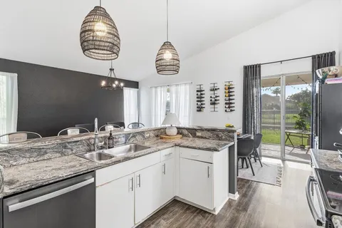 a kitchen with a table and chandelier