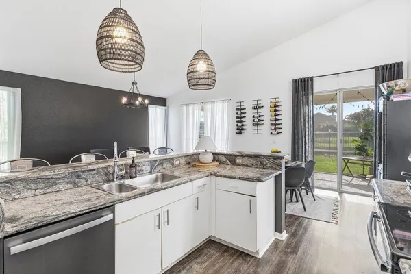 a kitchen with a table and chandelier