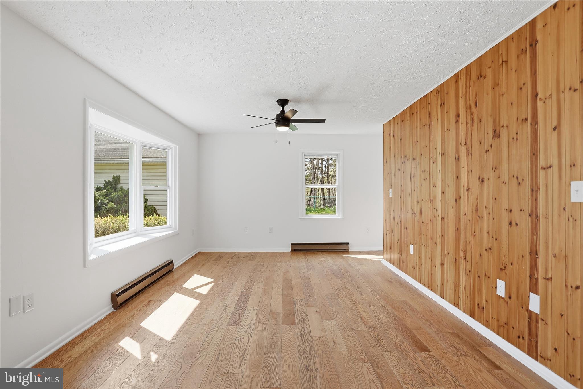 55 Highland Ridge Road Berkeley Springs, WV 25411 - Photo 12 of 44 wooden floor in an empty room with a window