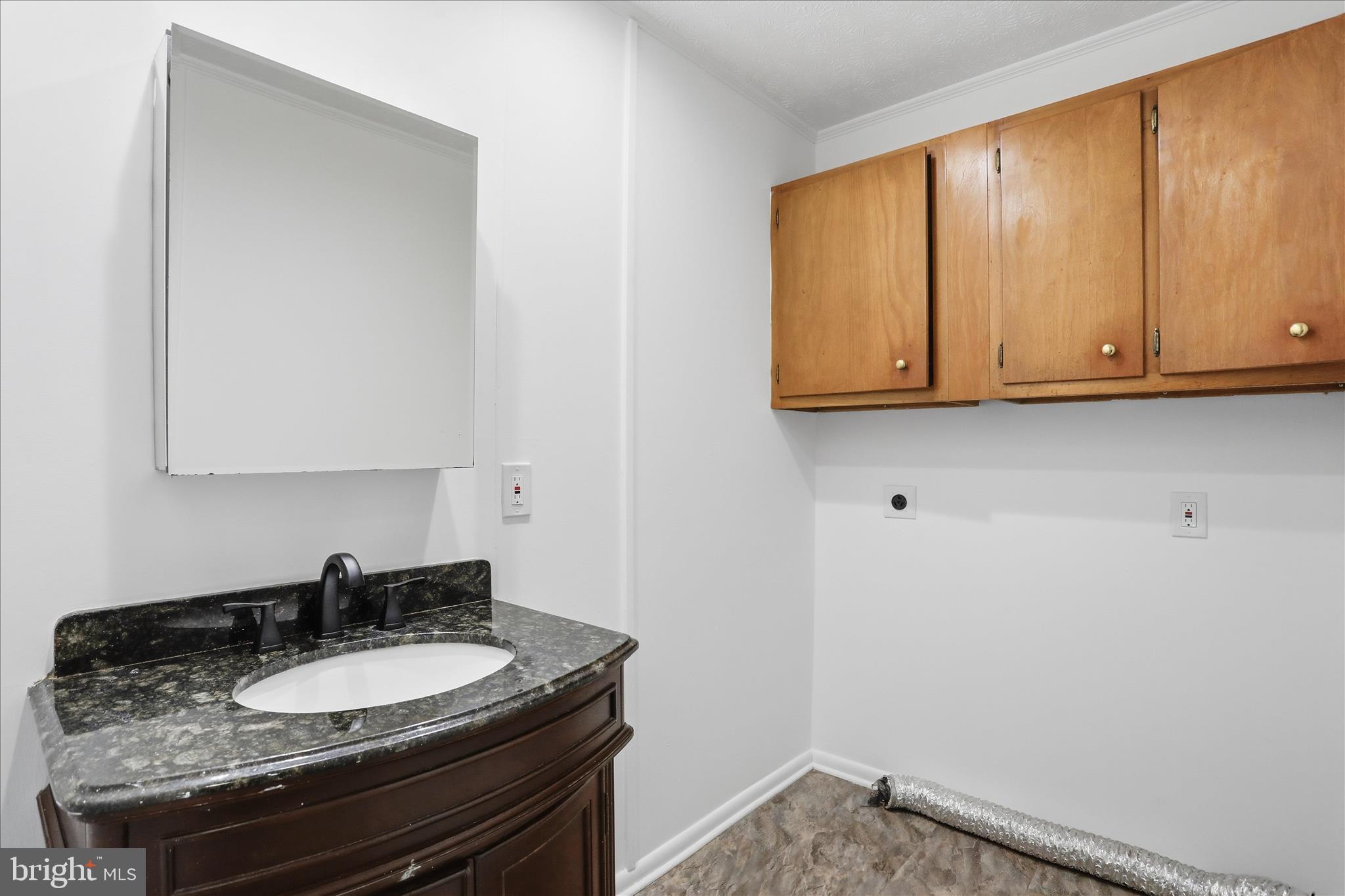 55 Highland Ridge Road Berkeley Springs, WV 25411 - Photo 24 of 44 a bathroom with a granite countertop sink and a mirror