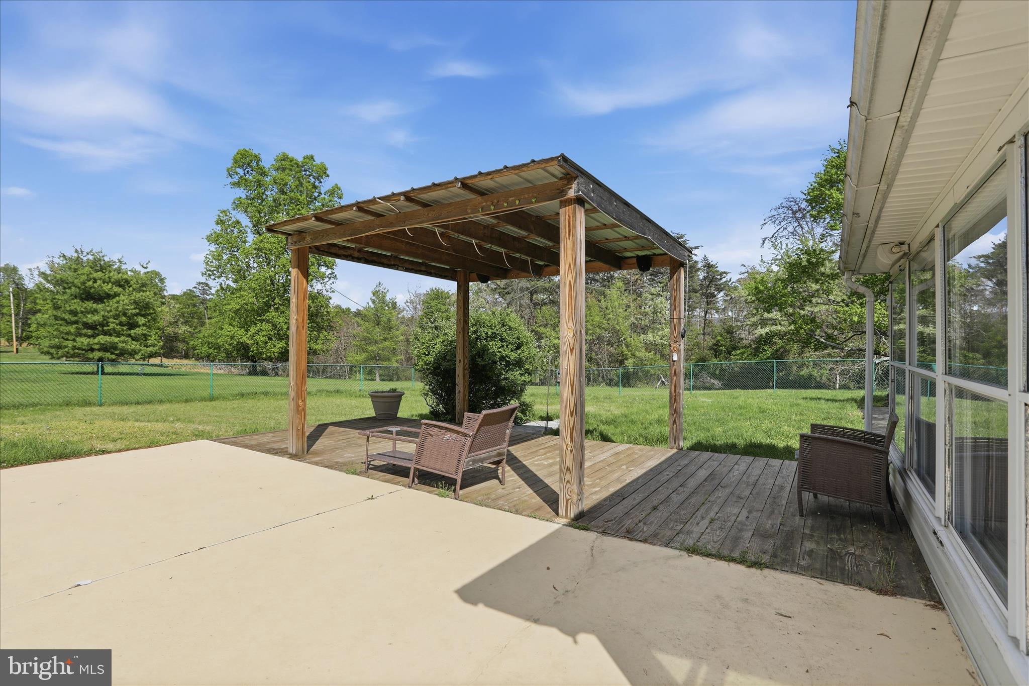 55 Highland Ridge Road Berkeley Springs, WV 25411 - Photo 30 of 44 a view of a patio with a table chairs and a backyard